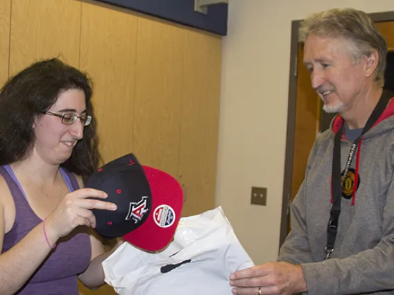 Ariella Gladstein accepts prize package from Research Data Center's Chris Reidy