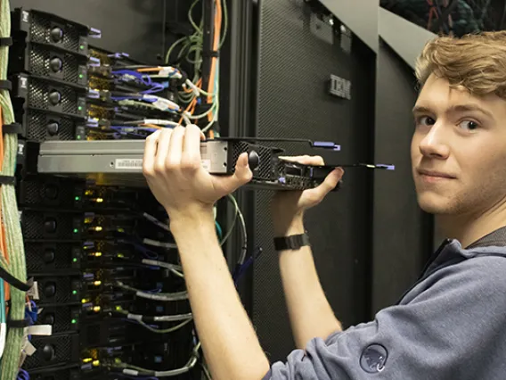 Alec Scott, a student worker in the RDC, replacing hardware in the El Gato system