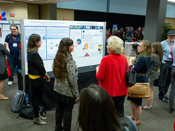 IT Summit attendees gathering at the Poster Session