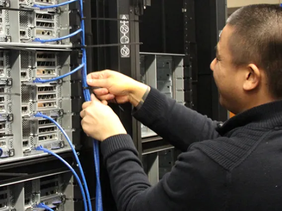 A tech from PCPC Direct installs new nodes in the Research Data Center