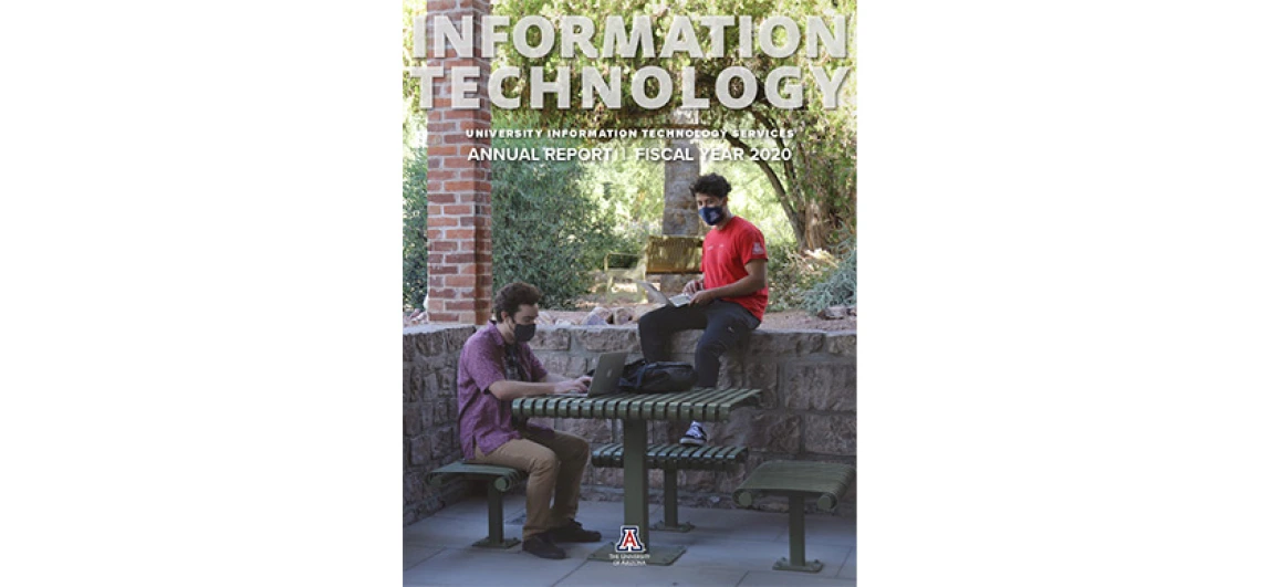 cover of the annual report - 2 students working on laptops at Old Main