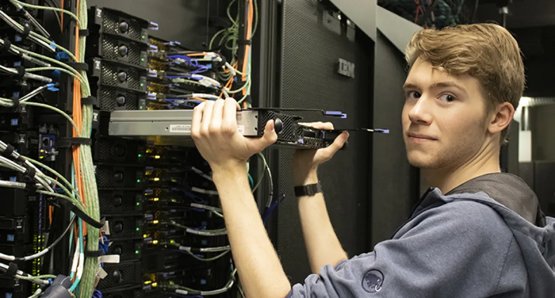 Alec Scott, a student worker in the RDC, replacing hardware in the El Gato system