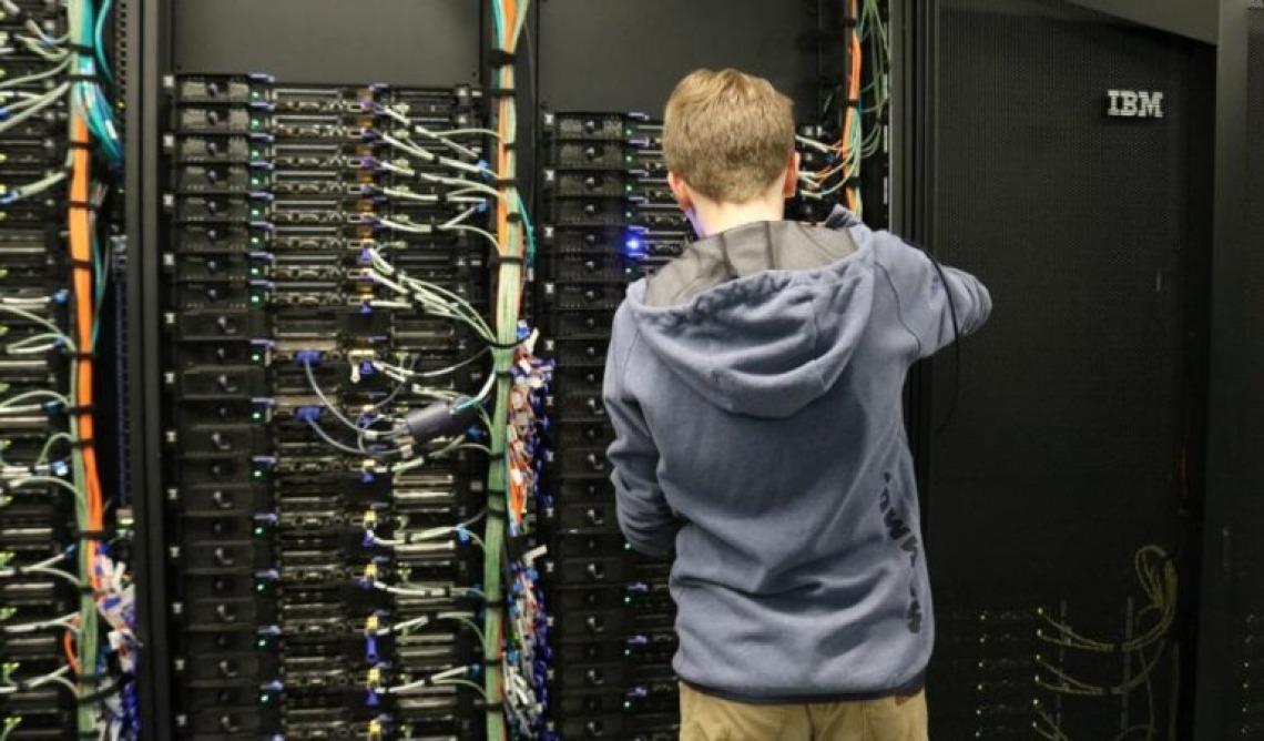 research computing staffer at University of Arizona updating a supercomputer