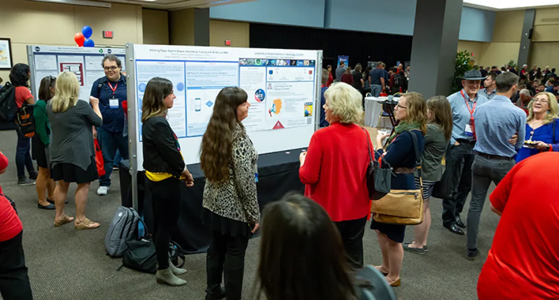 IT Summit attendees gathering at the Poster Session