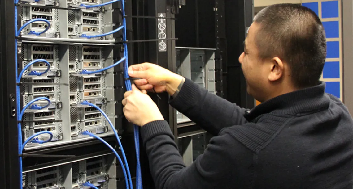 A tech from PCPC Direct installs new nodes in the Research Data Center