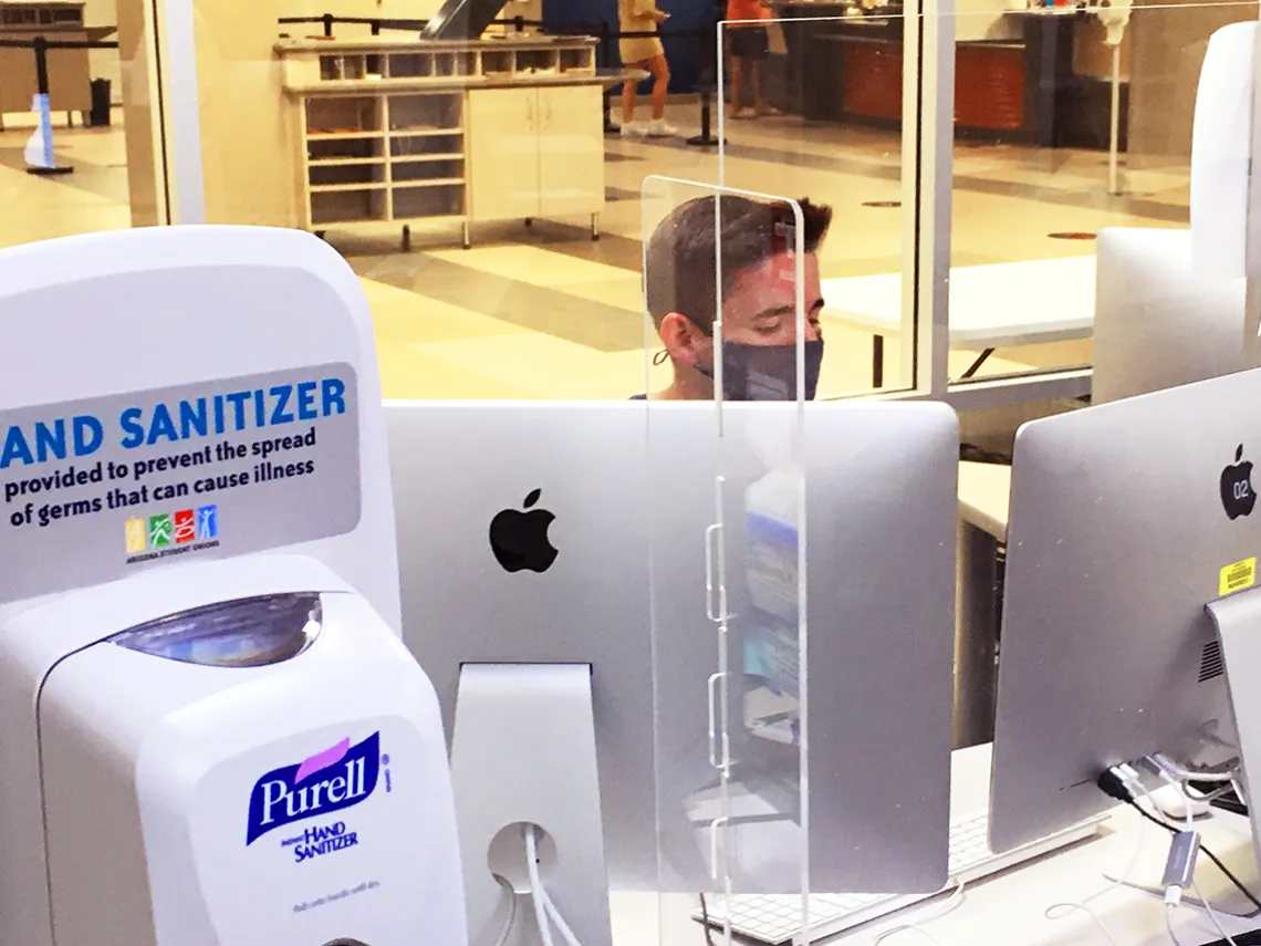 Student Union lab with hand sanitizer and acrylic barriers for the lab consultant