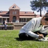 Welcome 2025 - Student on lawn in front of Old Main