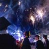 Students at Graduation with Fireworks overhead.