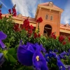 Old Main with Flowers in the foreground.
